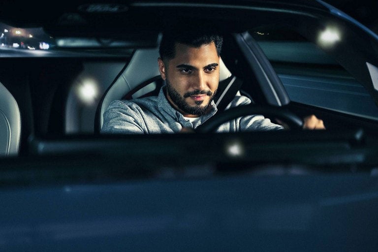 Driver inside Mustang focused on road